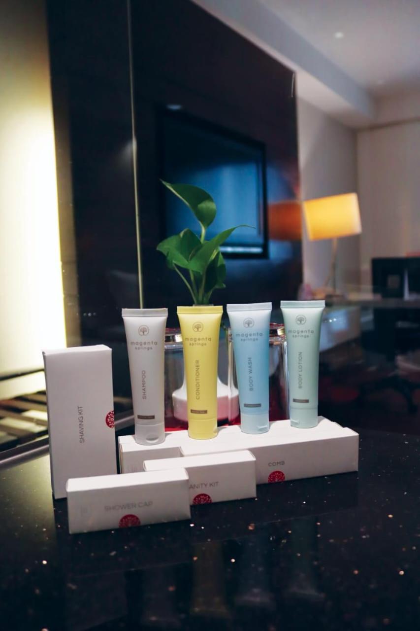 Seri Pacific Hotel Куала-Лумпур Экстерьер фото The image shows a collection of skincare products displayed on a surface. There are three tubes of cream in pastel colors (likely yellow, blue, and another shade), each likely representing different formulations or purposes. They are arranged beside 